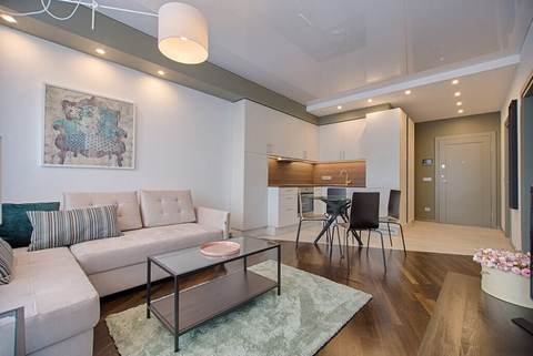 Bright open-plan living room with a sectional sofa and dining area