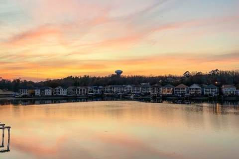 Sunset over a lake with homes along the shoreline